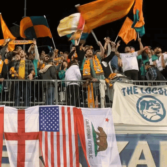 a california republic flag is being waved by fans