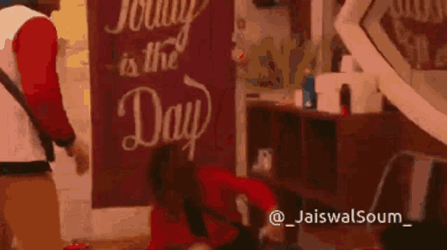 a sign that says " today is the day " hangs on a wall