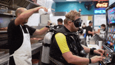 a man in a scuba suit is playing a slot machine in a restaurant