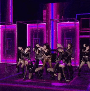 a woman in a fishnet top is dancing on a stage .