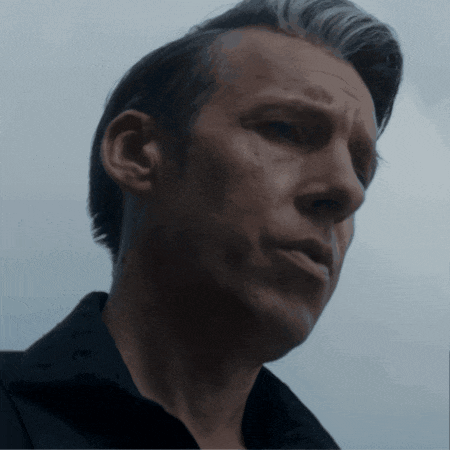 a close up of a man 's face with gray hair