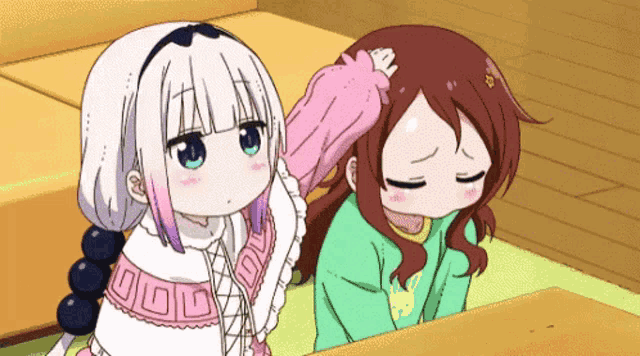 two anime girls are sitting next to each other and one is petting the other 's hair .