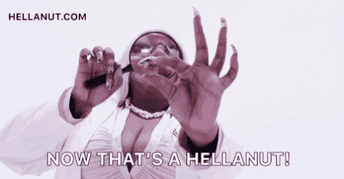 a woman is holding a magnifying glass in front of her face and says `` now that 's a hellanut ! ''