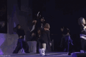a group of people are dancing on a stage and the words angevon are on the bottom