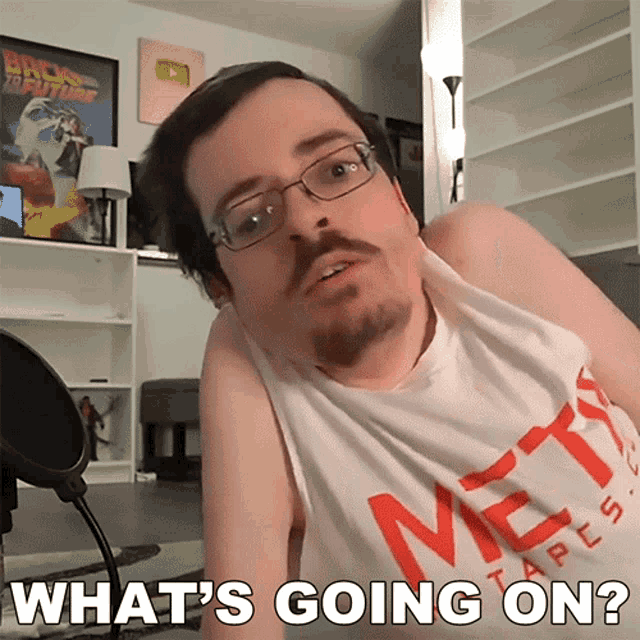 a man with glasses and a beard is asking what 's going on