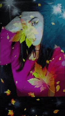 a woman in a purple sweater is surrounded by leaves
