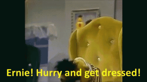 a yellow chair with the words " ernie hurry and get dressed " written on it