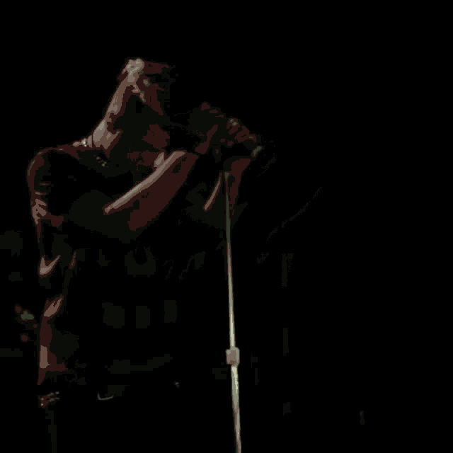 a crowd of people are holding their phones up in the dark
