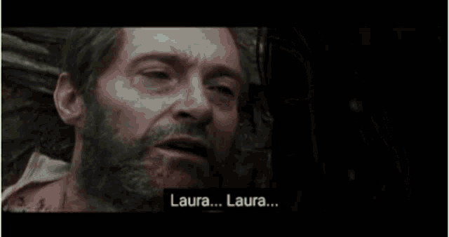 a man and a woman are standing next to each other in the woods and the woman is crying .