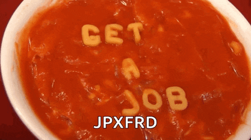a bowl of tomato soup with the words get a job written out of pasta