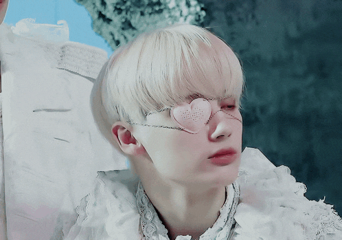 a close up of a person wearing heart shaped eye glasses