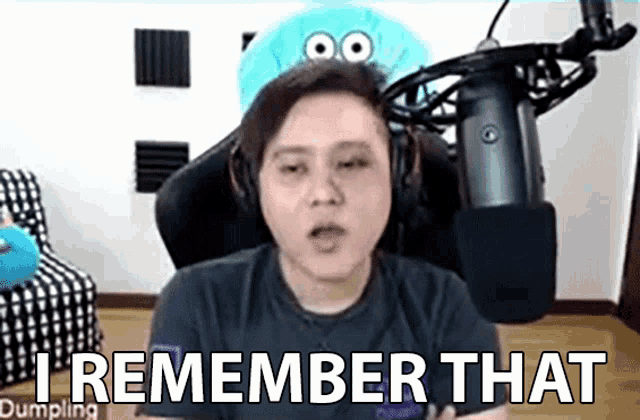 a man is sitting in front of a microphone and saying `` i remember that dumpling '' .