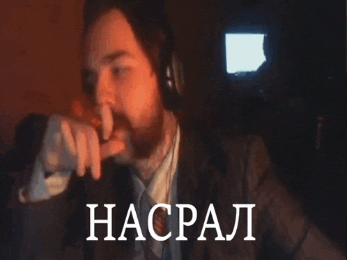 a man wearing headphones is smoking a cigarette and the word haspal is visible in the background