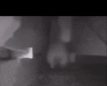 a black and white photo of a person 's hand on a table