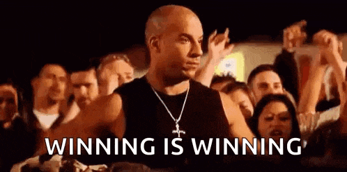 vin diesel is standing in front of a crowd of people and saying winning is winning .