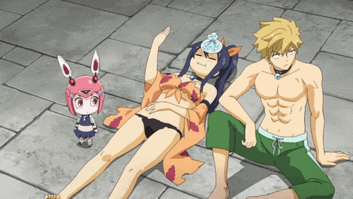 a girl in a bikini is laying on the ground next to a man and a girl
