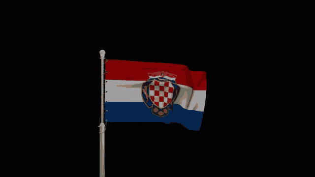 a red white and blue flag with a coat of arms on a pole