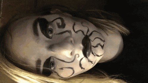 a close up of a person 's face with a spider painted on it