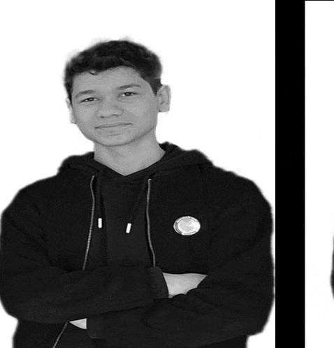 a black and white photo of a young man with his arms crossed wearing a black hoodie