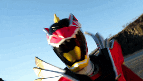 a close up of a person wearing a red and black costume