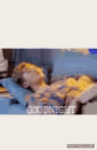 a blurry picture of a person laying on a bed with a polka dot pattern .