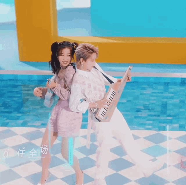 a woman in pink shorts stands next to a man holding a piano keyboard