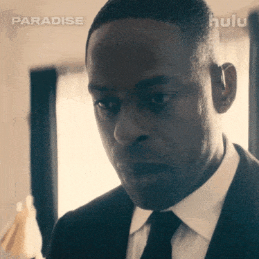 a man in a suit and tie is featured on hulu 's paradise