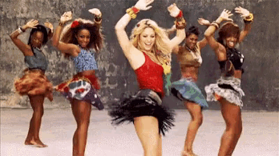 a group of women are dancing together in a line