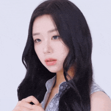 a woman with long black hair and blue eyes