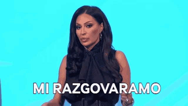a woman in a black dress is holding her hand to her forehead and says `` mi razgovaramo '' .