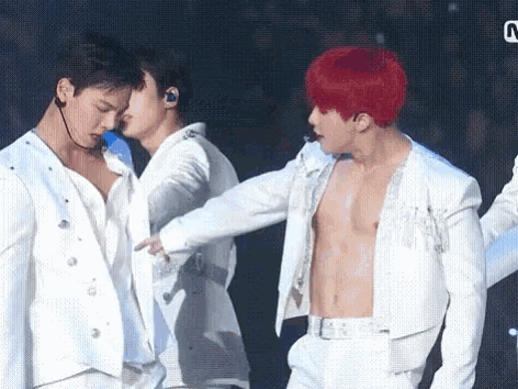 a group of men are standing next to each other on a stage .