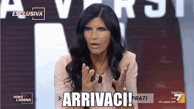 a woman is making a funny face while talking on a television show and the words arrivaci prati are written on the screen .