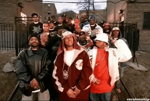 a group of men standing next to each other in front of a fence with the caption cocainecrisp
