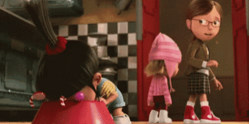 three cartoon characters from despicable me are standing next to each other in a room .