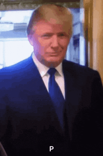 a man in a suit and tie with the letter p on the bottom right