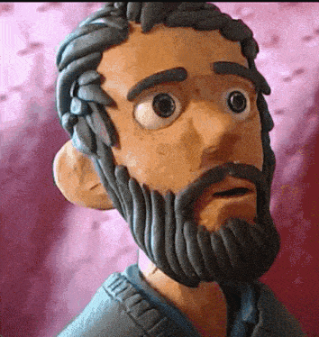a clay sculpture of a man with a beard and big eyes