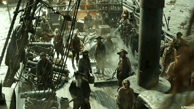 a group of men are standing on a deck of a ship with a watermark that says alphagen.uk