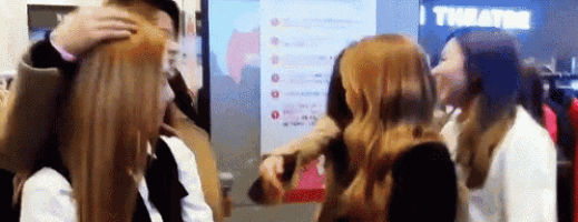 a group of women are standing next to each other in front of a screen .