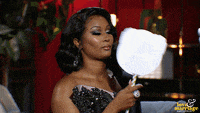 a woman in a black and white dress is holding a cotton candy