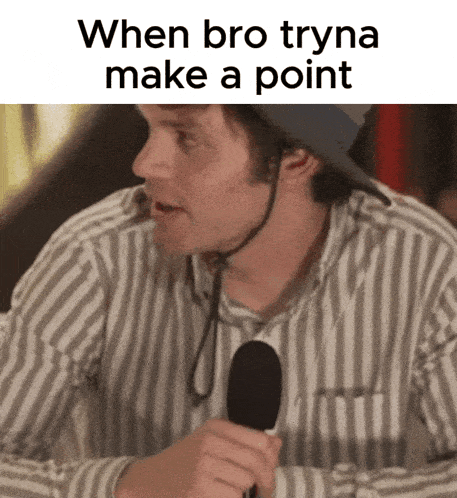 a man wearing a helmet and a striped shirt is holding a microphone and says when bro tryna make a point