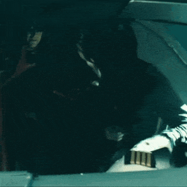 a woman in a wonder woman costume is standing in a cockpit of an airplane .