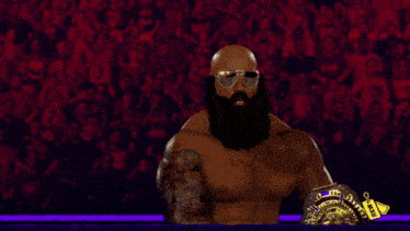 a man with a beard is holding a championship belt
