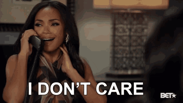 a woman talking on a phone with the words i don 't care behind her