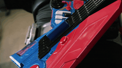 a red and blue toy guitar with the letter e on the top