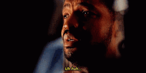 a close up of a man 's face with the words uh-huh written next to him .