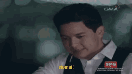 a man in a white shirt and black vest says siomail on a screen