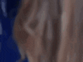 a close up of a person 's face with a blue shirt on .