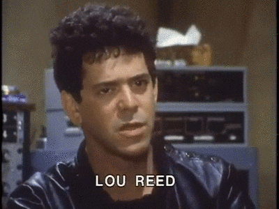 a close up of a man 's face with lou reed written on the bottom