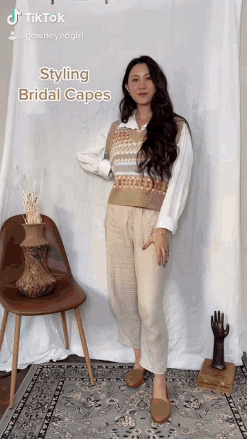 a woman is wearing a sweater vest and pants and a white shirt