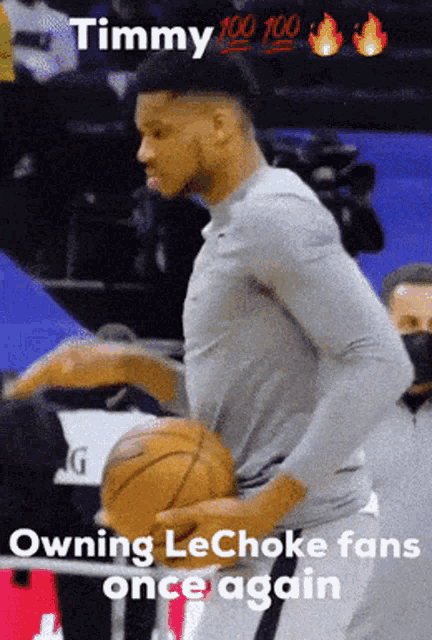 a man holding a basketball with the words timmy owning lechoke fans once again